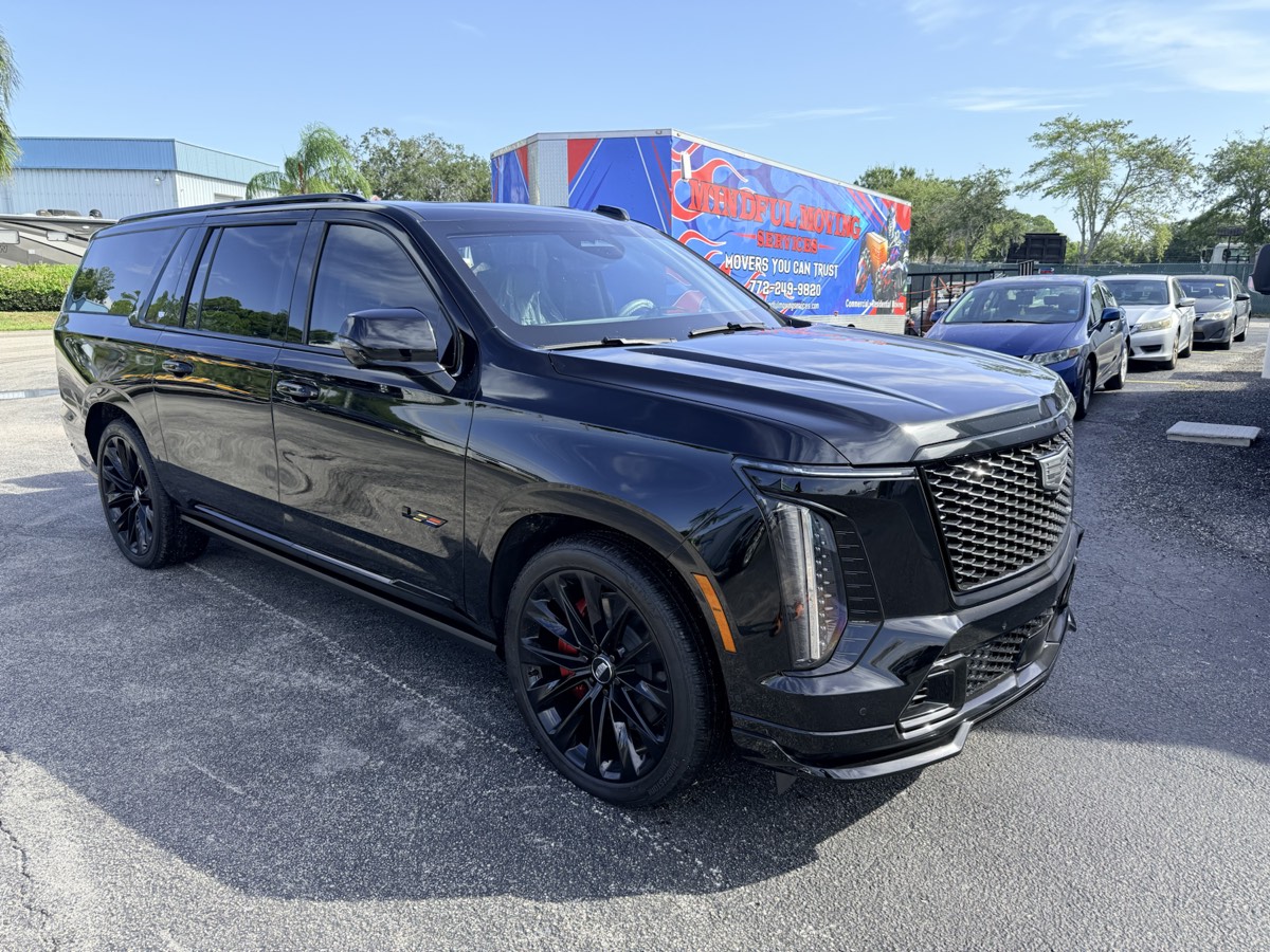 Detailed black Cadillac Escalade in bright Florida sunlight